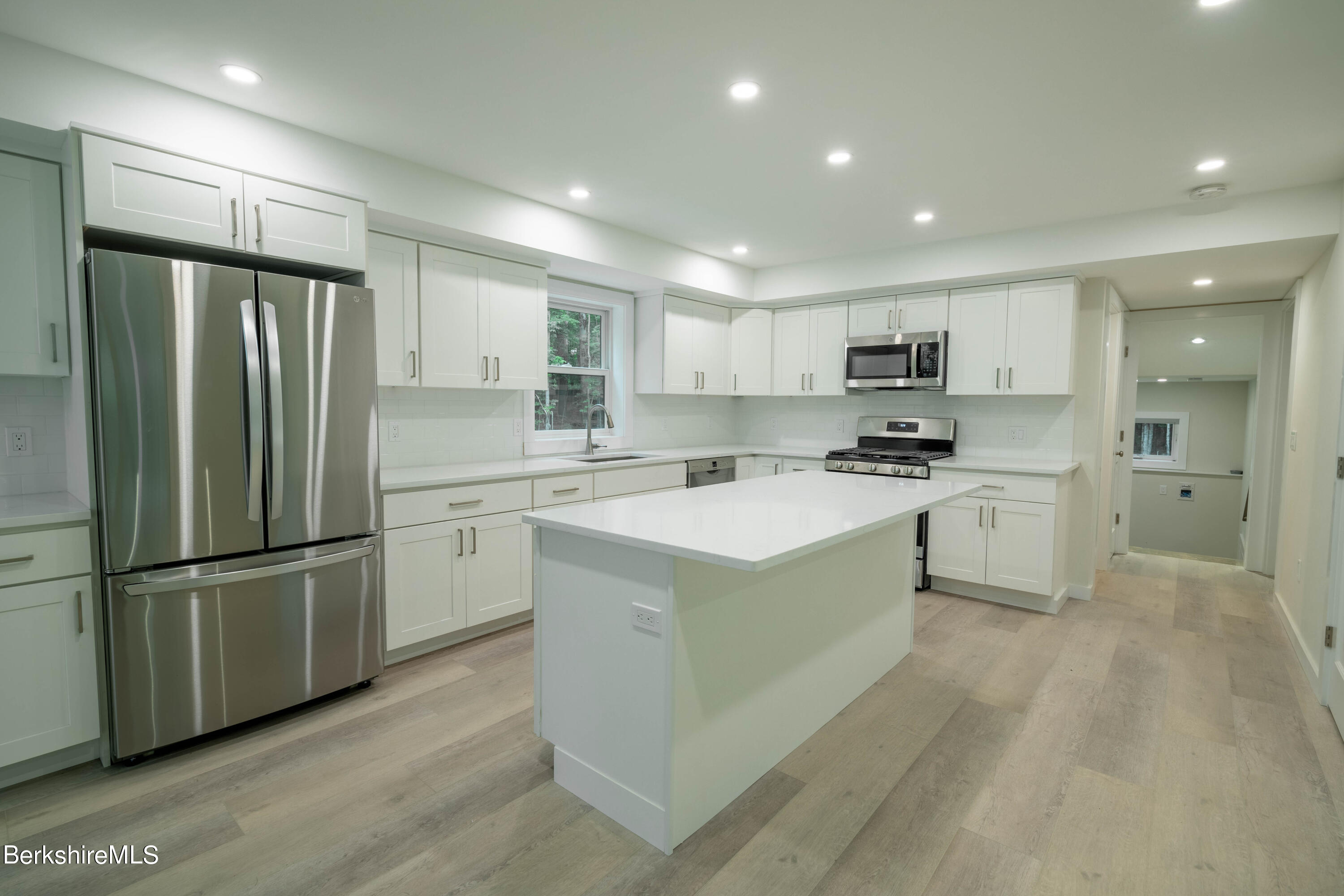 220 Hupi Road Monterey, MA 01245 - Photo 17 of 38 a kitchen with a refrigerator a sink and cabinets