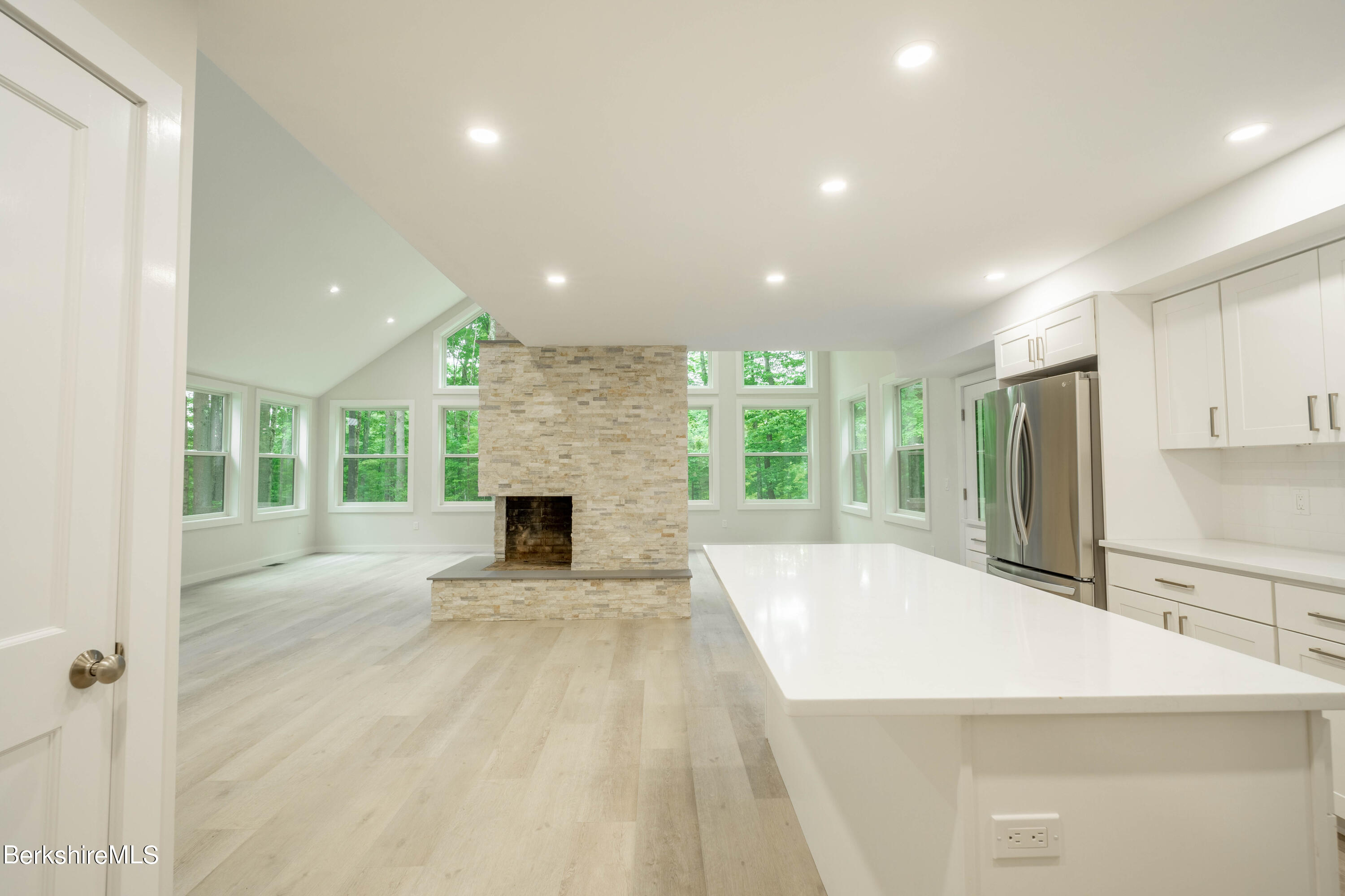 220 Hupi Road Monterey, MA 01245 - Photo 29 of 38 a large white kitchen with granite countertop a large window and a refrigerator