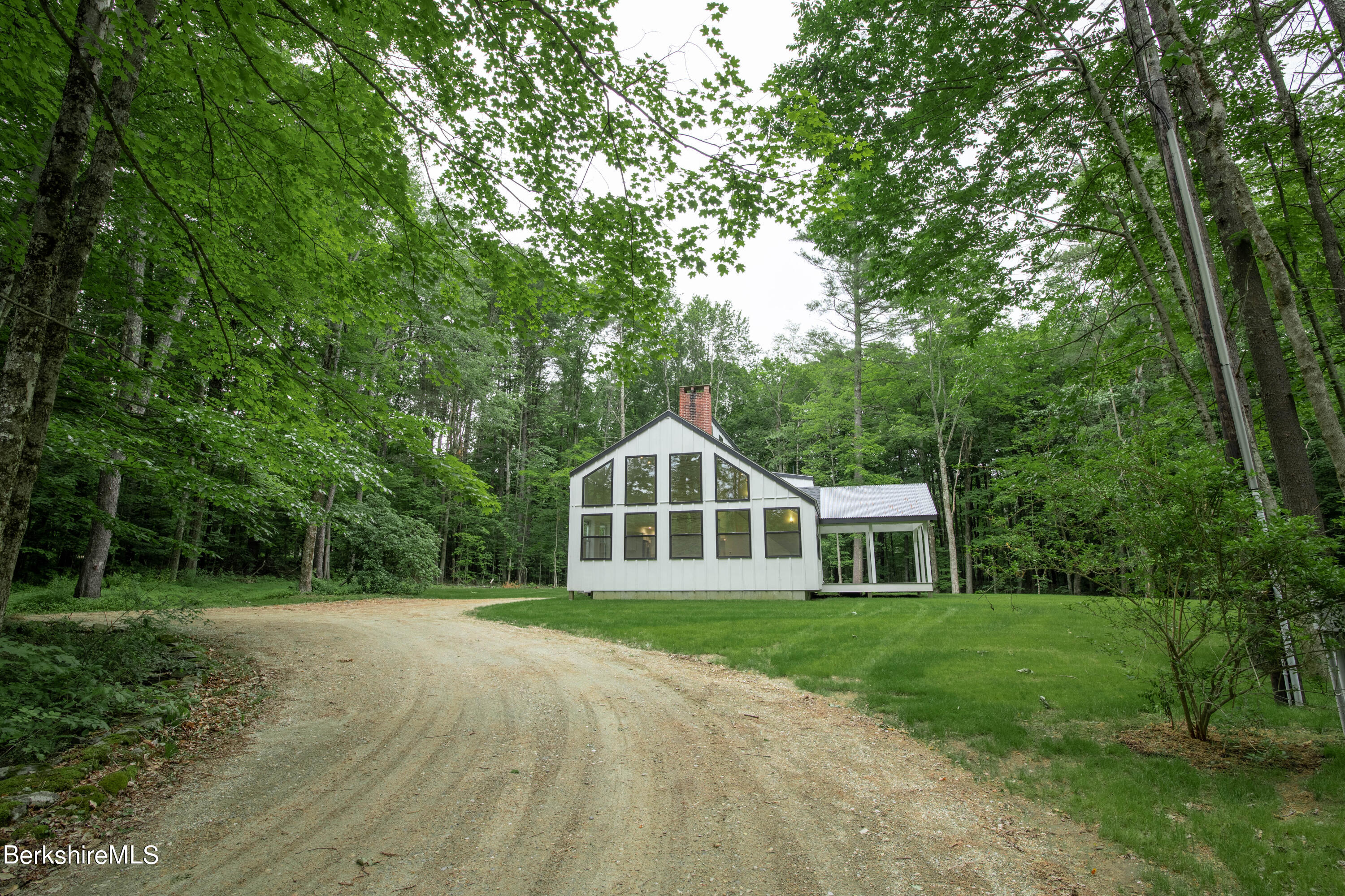220 Hupi Road Monterey, MA 01245 - Photo 3 of 38 a front view of a house with a yard