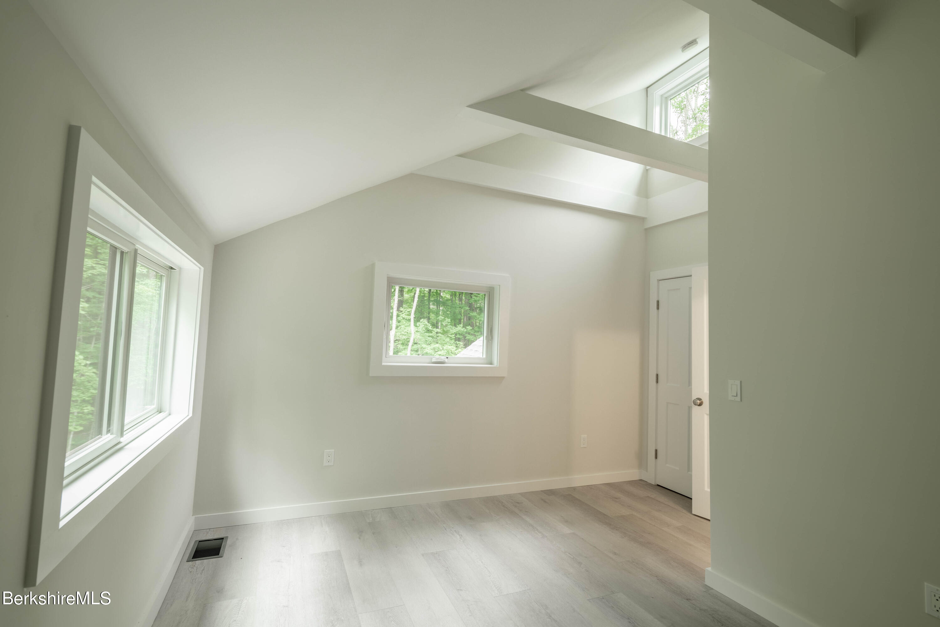 220 Hupi Road Monterey, MA 01245 - Photo 33 of 38 an empty room with wooden floor and windows