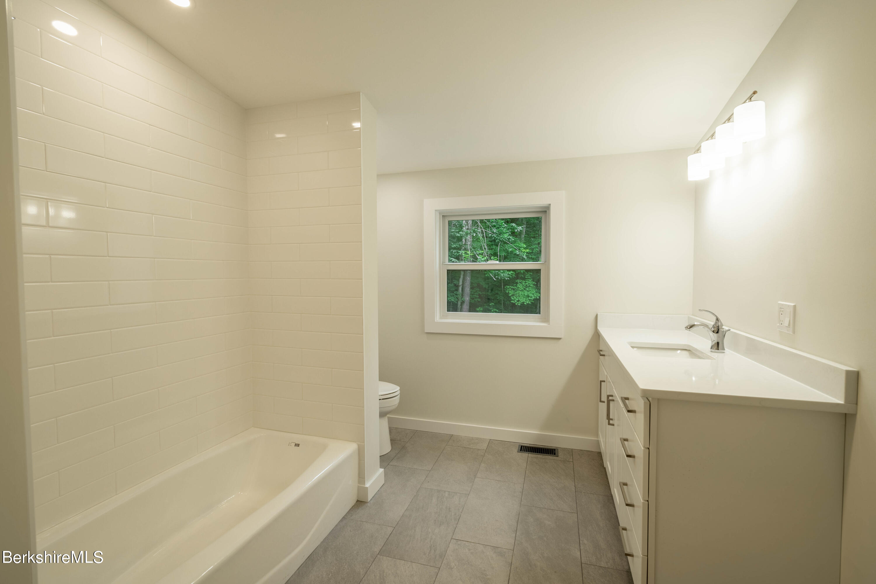 220 Hupi Road Monterey, MA 01245 - Photo 35 of 38 a bathroom with a tub sink and a vanity