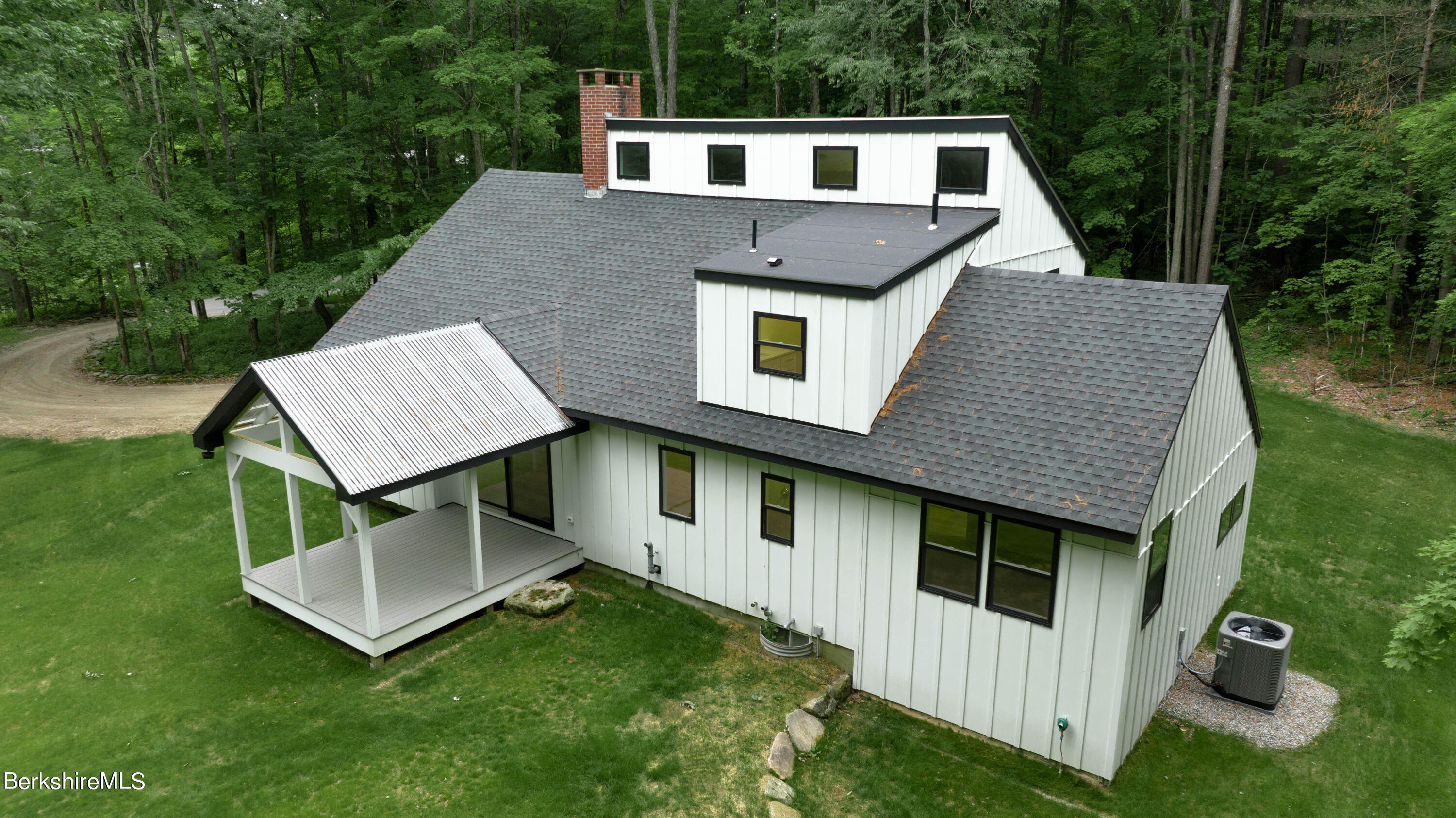 220 Hupi Road Monterey, MA 01245 - Photo 9 of 38 a front view of a house with a yard