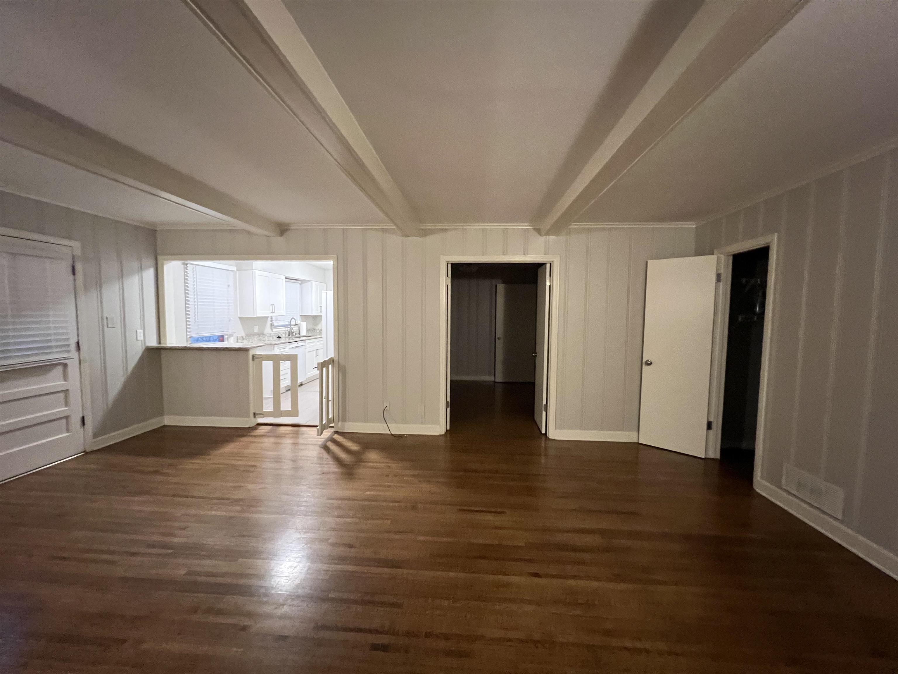 1653 Colonial Road Memphis, TN 38117 - Photo 14 of 15 a view of an empty room with wooden floor and windows