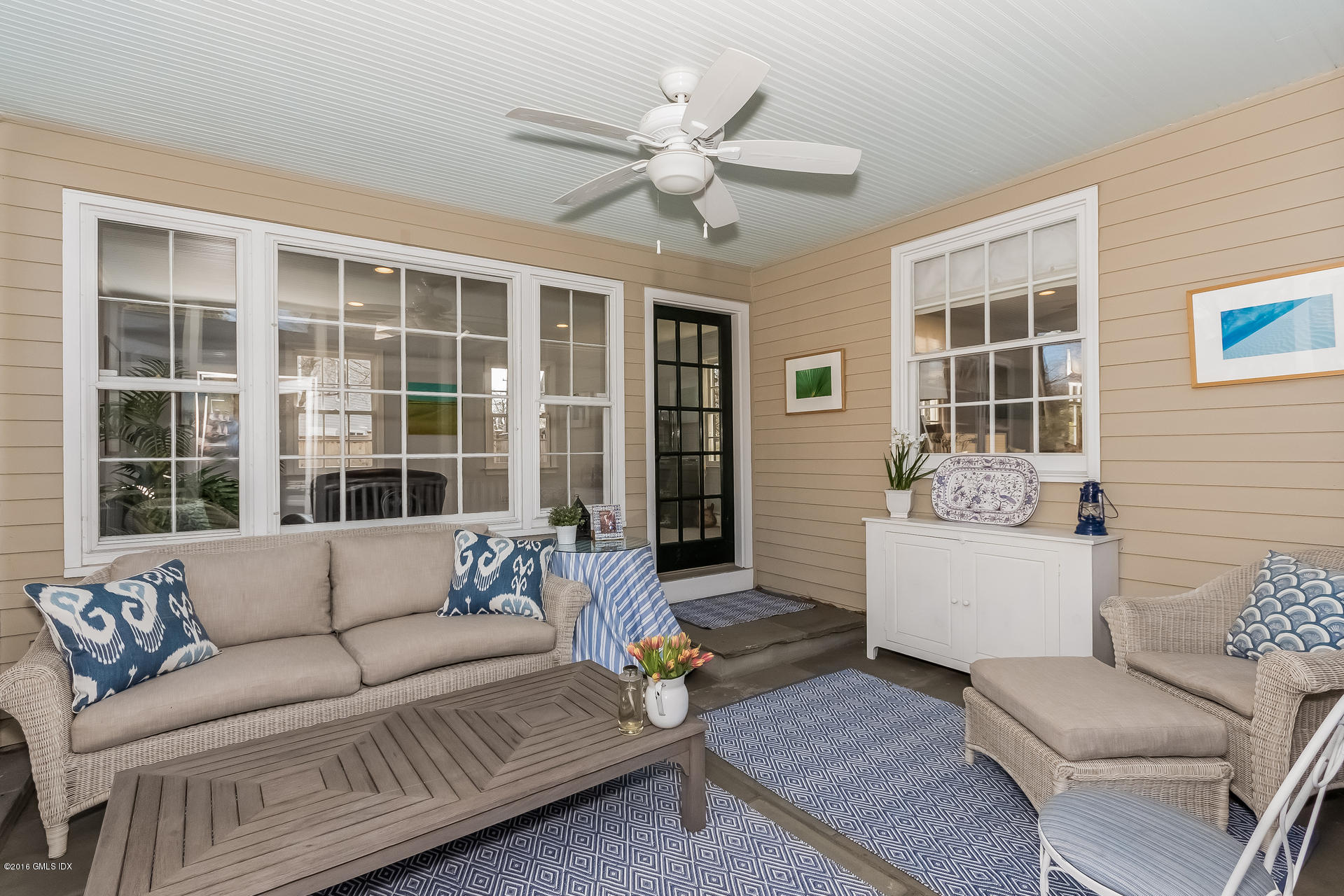 122 Hollow Tree Ridge Road Darien, CT 06820 - Photo 27 of 49 a living room with furniture and window with floor to ceiling windows