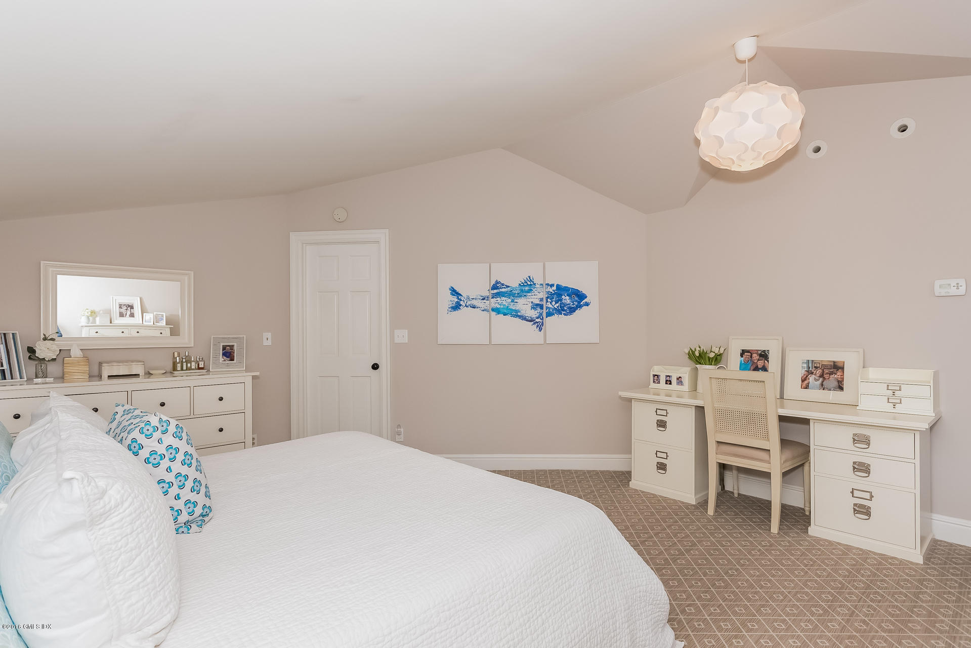 122 Hollow Tree Ridge Road Darien, CT 06820 - Photo 31 of 49 a bedroom with a bed and a chandelier