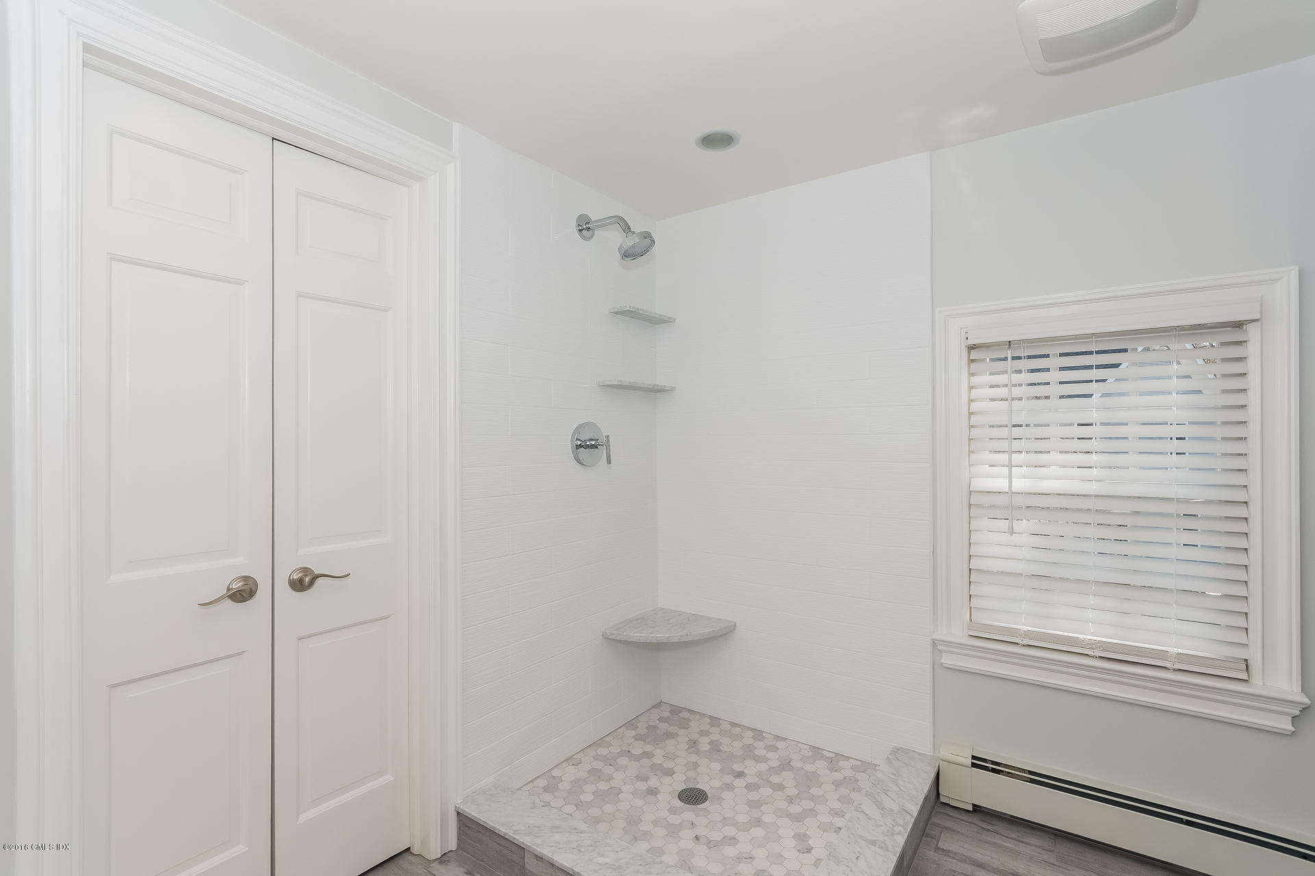 122 Hollow Tree Ridge Road Darien, CT 06820 - Photo 35 of 49 a bathroom with a toilet and a window
