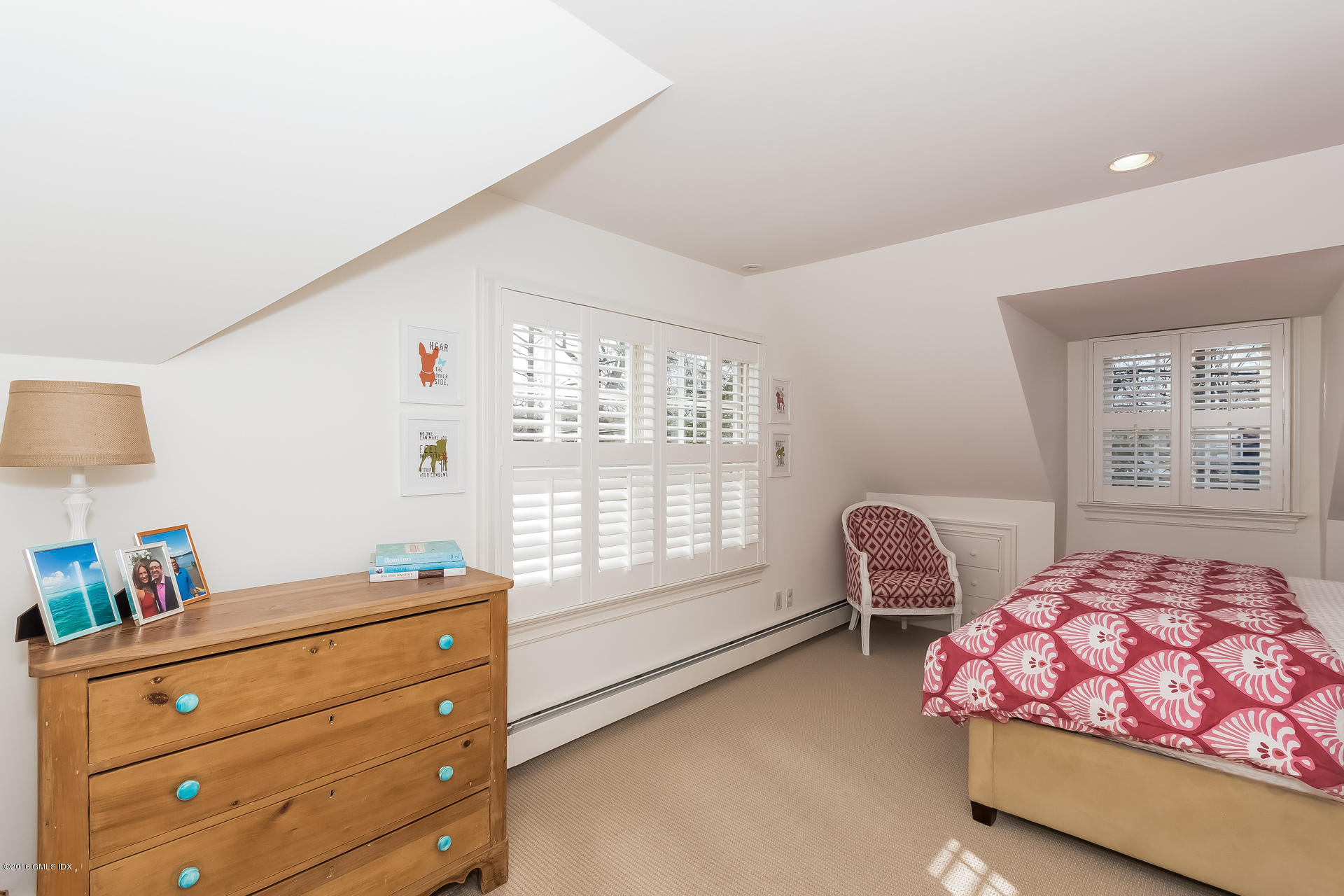122 Hollow Tree Ridge Road Darien, CT 06820 - Photo 38 of 49 a bedroom with a bed and a window with chair