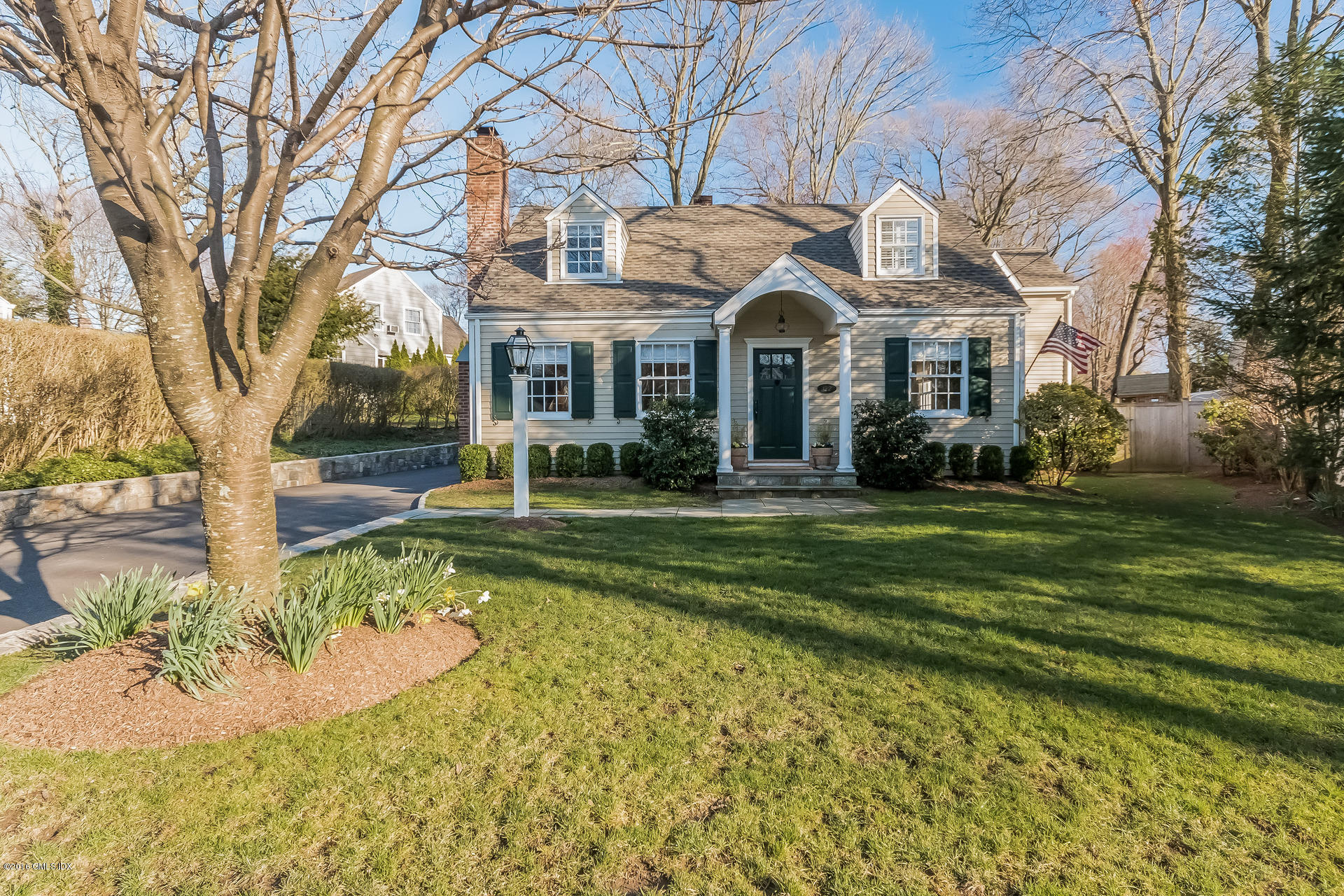 122 Hollow Tree Ridge Road Darien, CT 06820 - Photo 6 of 49 a view of a white house with a big yard and potted plants and large trees