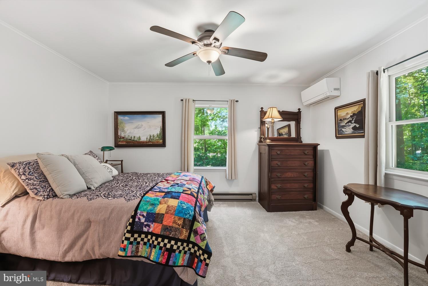814 Wrights Neck Road Centreville, MD 21617 - Photo 41 of 53 a bedroom with a bed and a chandelier