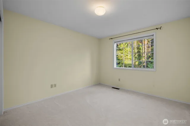 a bathroom with a granite countertop sink toilet and mirror