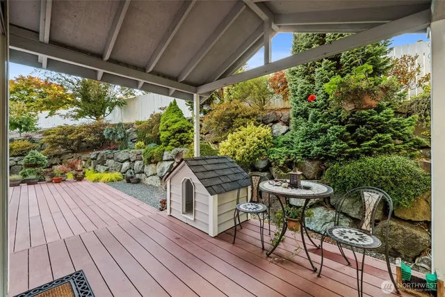 a view of a patio with table and chairs potted plants