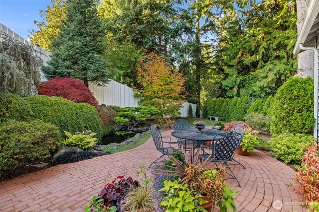 a view of a garden with a house in the background