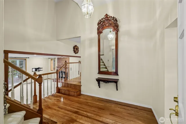 a view of entryway and hall with wooden floor