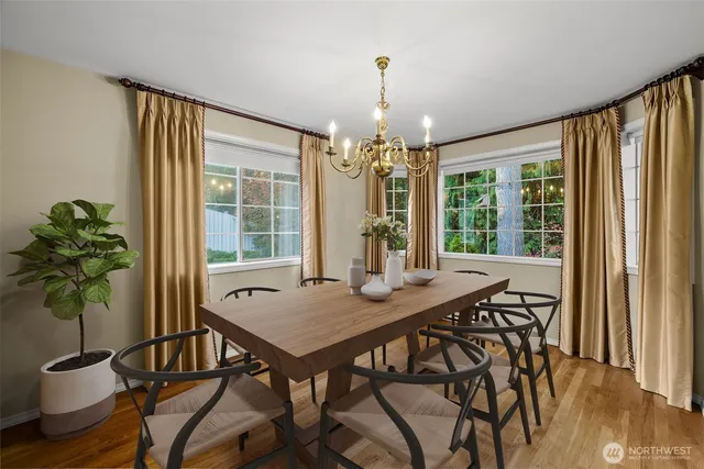 a view of a dining room with furniture window and wooden floor