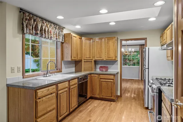 a kitchen with a sink stove and cabinets