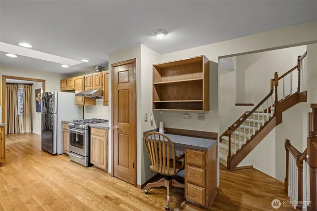 a view of a kitchen with a sink oven cabinets and a kitchen