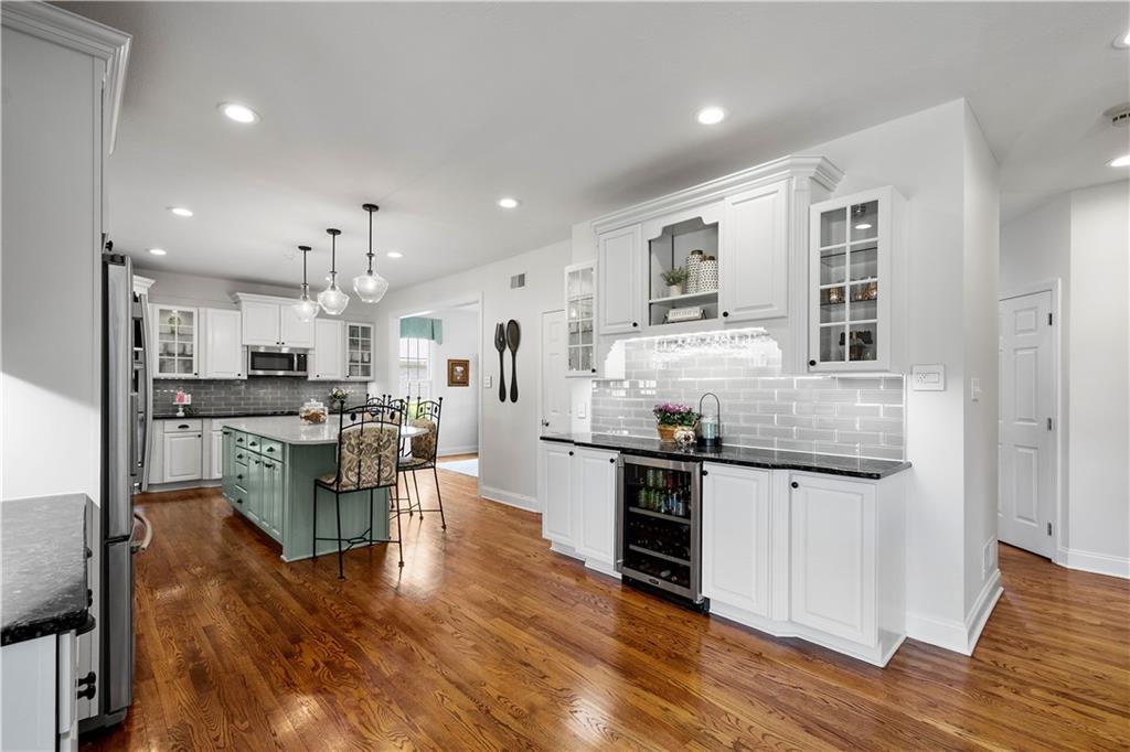 3012 East Ridge Drive Gibsonia, PA 15044 - Photo 13 of 50 a kitchen with stainless steel appliances kitchen island granite countertop a stove top oven a sink a dining table and chairs