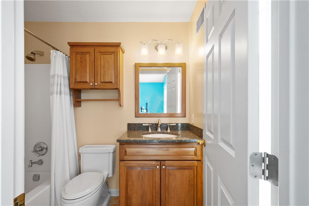 3012 East Ridge Drive Gibsonia, PA 15044 - Photo 22 of 50 a bathroom with a granite countertop sink toilet and mirror