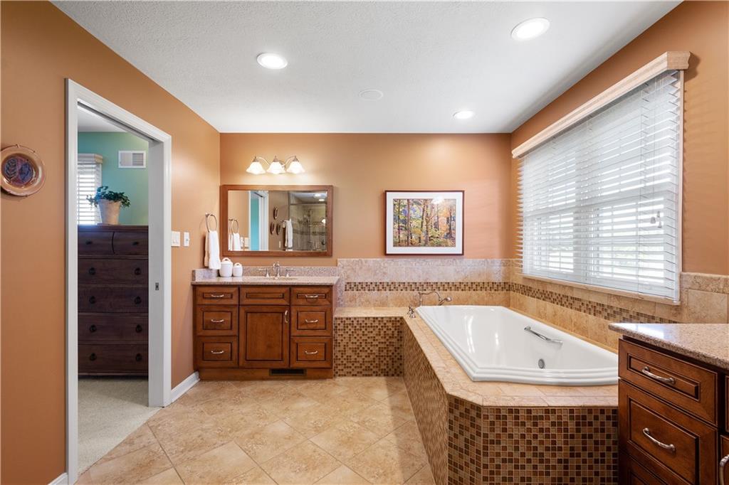 3012 East Ridge Drive Gibsonia, PA 15044 - Photo 28 of 50 a spacious bathroom with a granite countertop tub sink and mirror