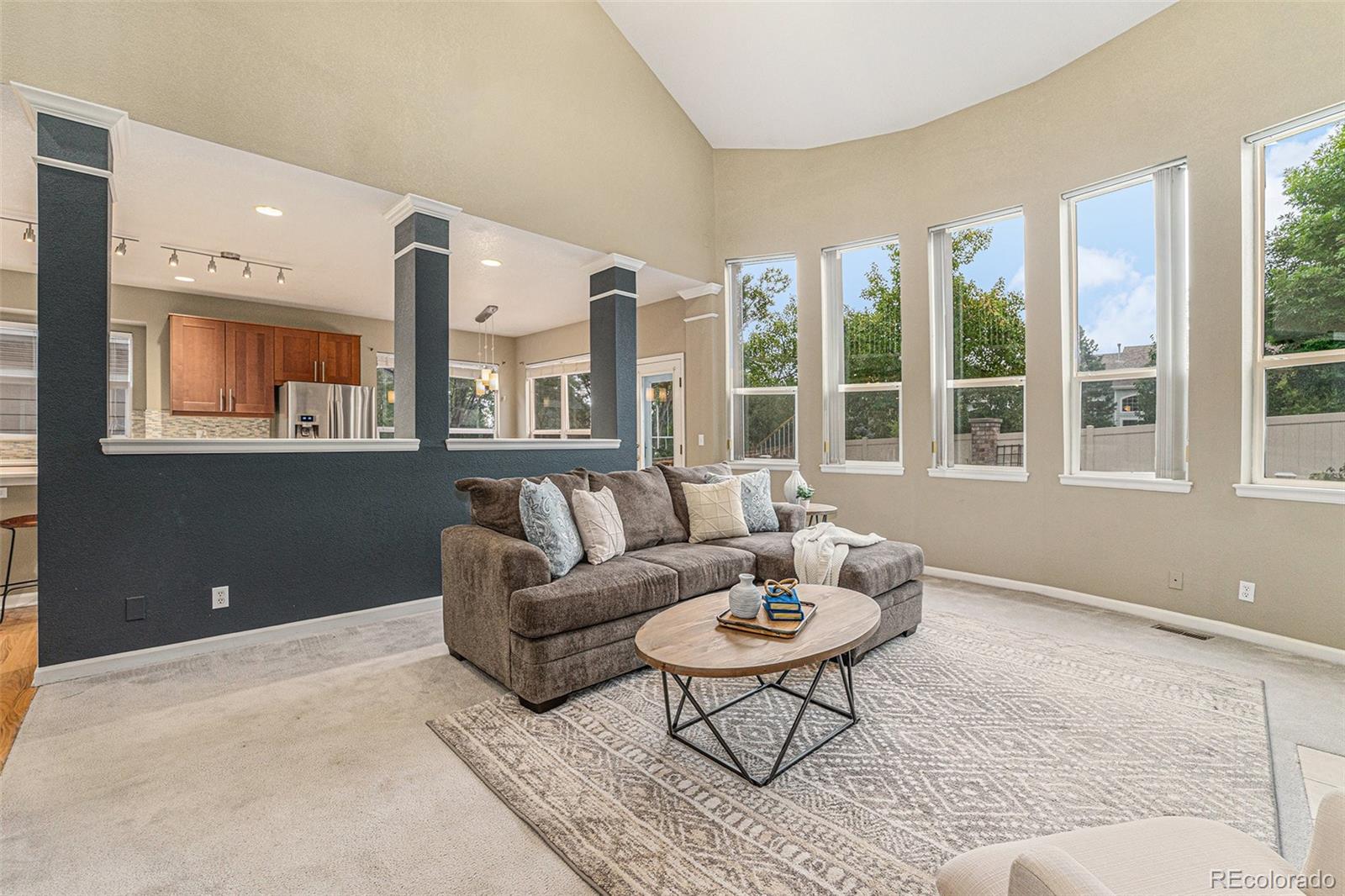 9705 Carr Circle Westminster, CO 80021 - Photo 11 of 43 a living room with furniture and floor to ceiling windows