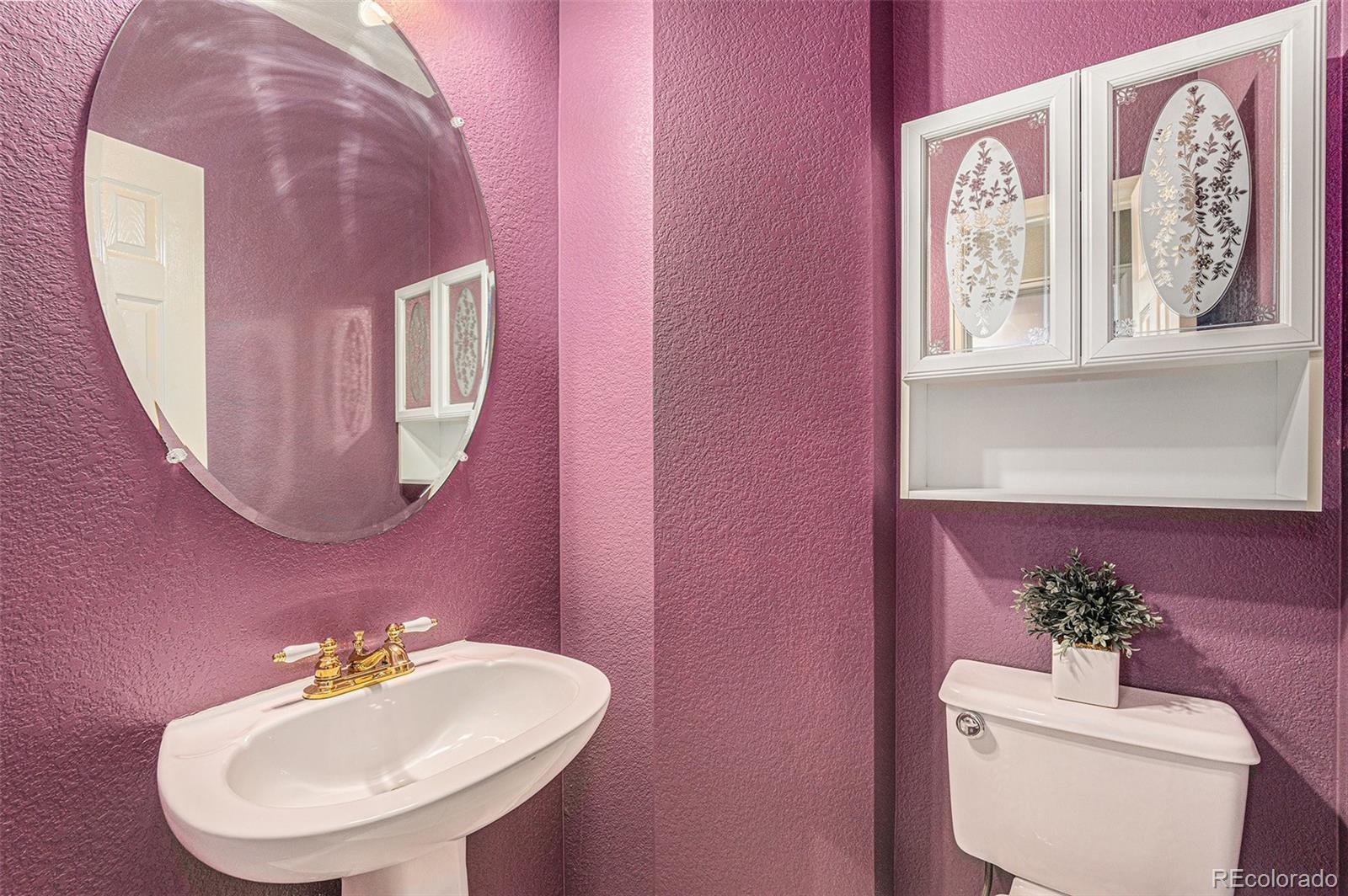 9705 Carr Circle Westminster, CO 80021 - Photo 16 of 43 a bathroom with a sink mirror and vanity