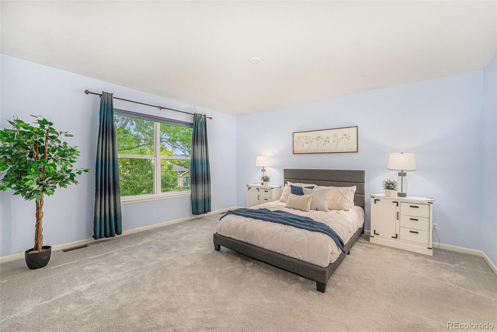 9705 Carr Circle Westminster, CO 80021 - Photo 20 of 43 a spacious bedroom with a bed and a window