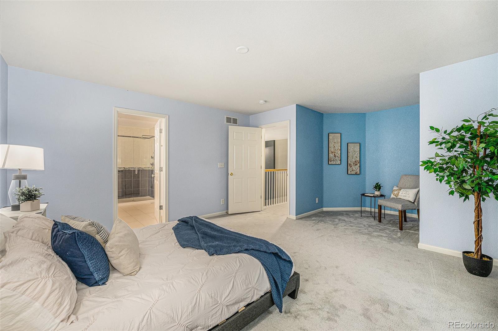 9705 Carr Circle Westminster, CO 80021 - Photo 21 of 43 a bedroom with a bed and a potted plant