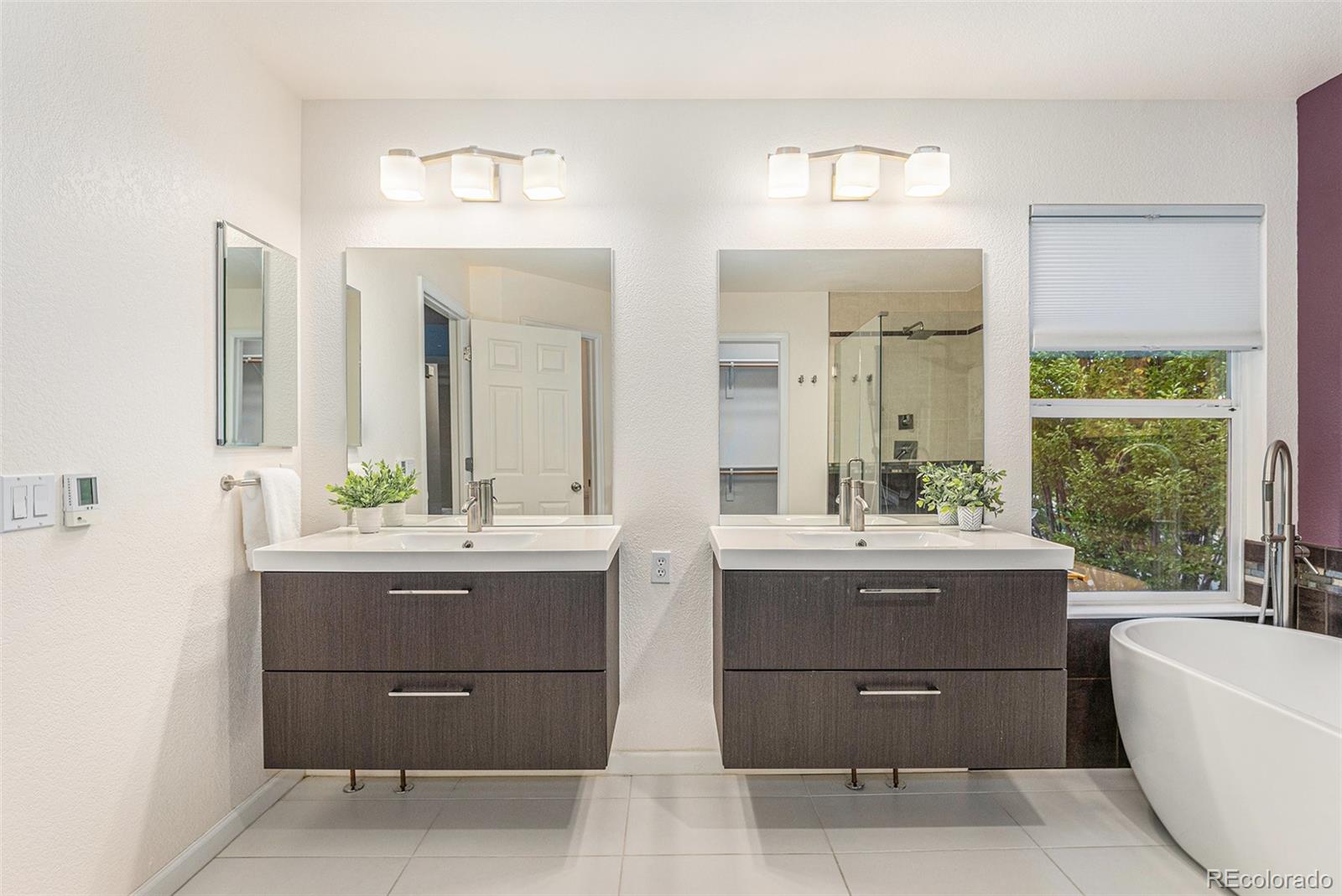 9705 Carr Circle Westminster, CO 80021 - Photo 25 of 43 a bathroom with a tub sink and mirror