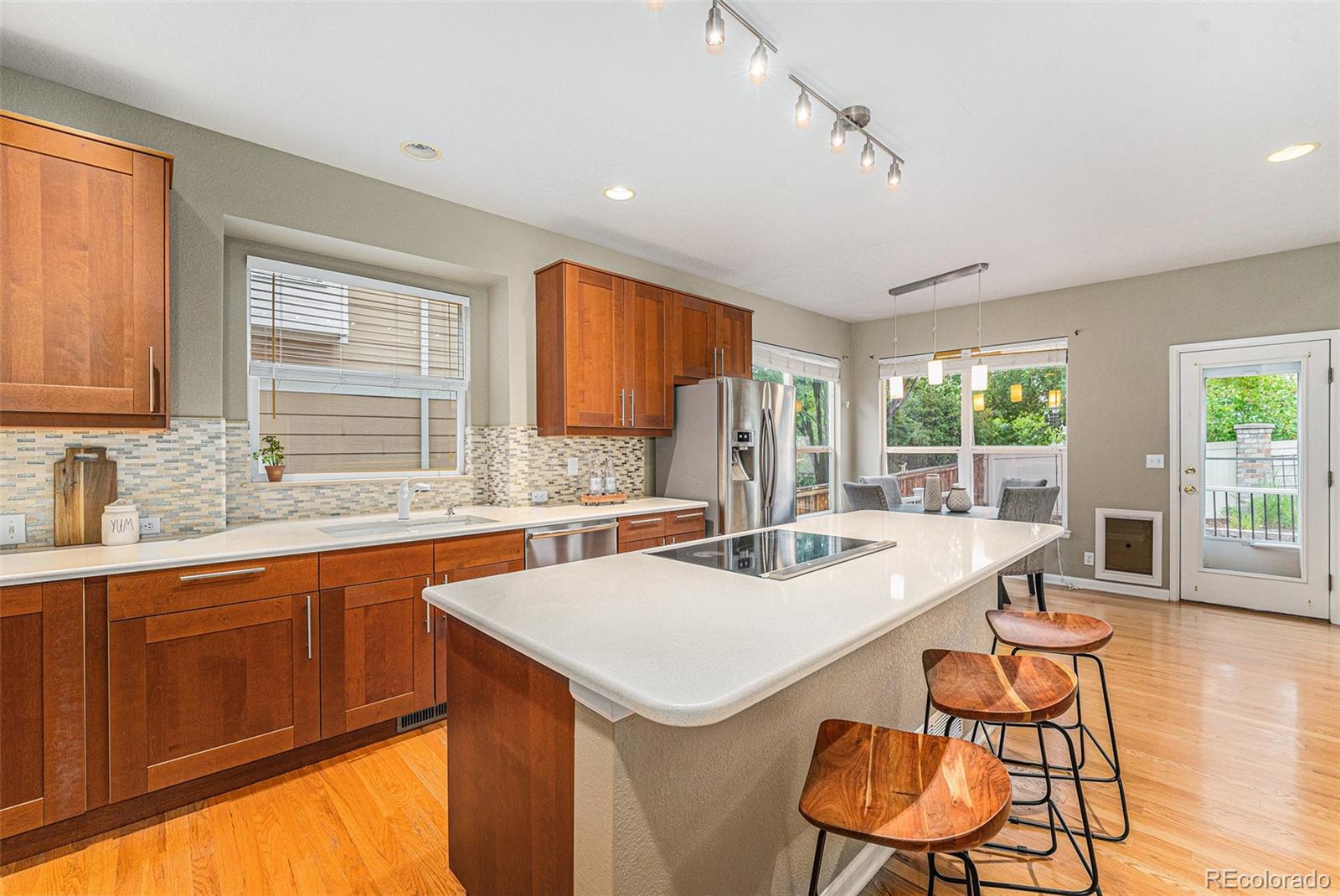 9705 Carr Circle Westminster, CO 80021 - Photo 5 of 43 a kitchen with a stove a sink a dining table and chairs