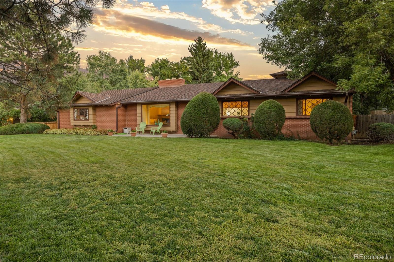 a view of a house with yard and a tree