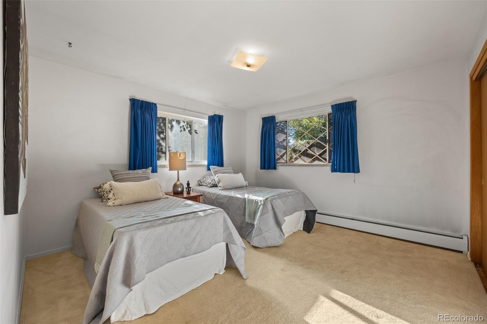13780 Crabapple Road Golden, CO 80401 - Photo 16 of 39 a bedroom with two beds and a painting on the wall