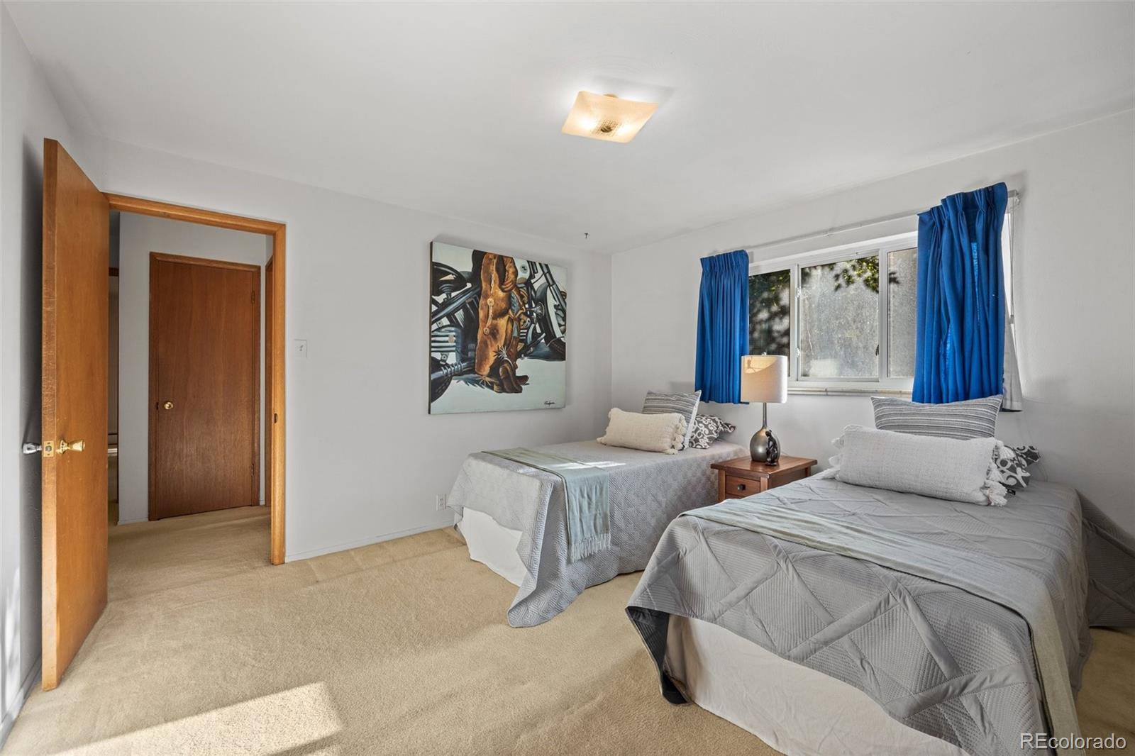 13780 Crabapple Road Golden, CO 80401 - Photo 17 of 39 a bedroom with two beds and painting on the wall