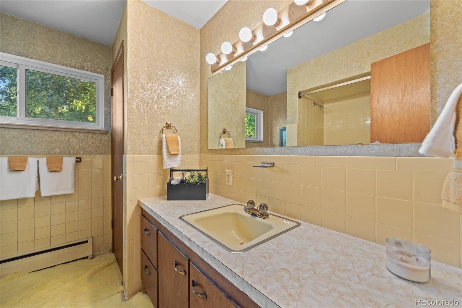13780 Crabapple Road Golden, CO 80401 - Photo 18 of 39 a bathroom with a sink vanity granite tub and mirror