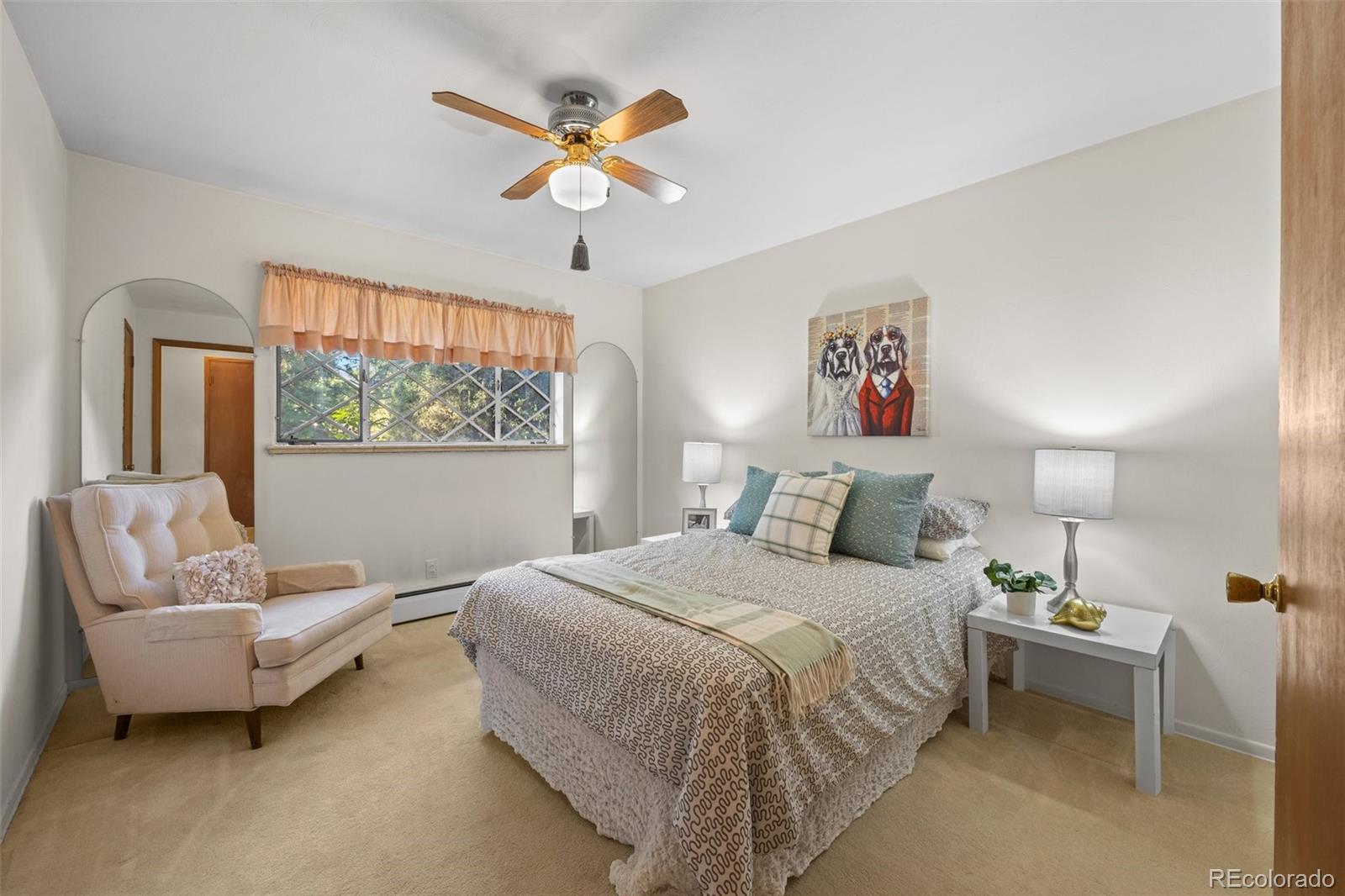 13780 Crabapple Road Golden, CO 80401 - Photo 19 of 39 a bedroom with a bed a couch and a chandelier