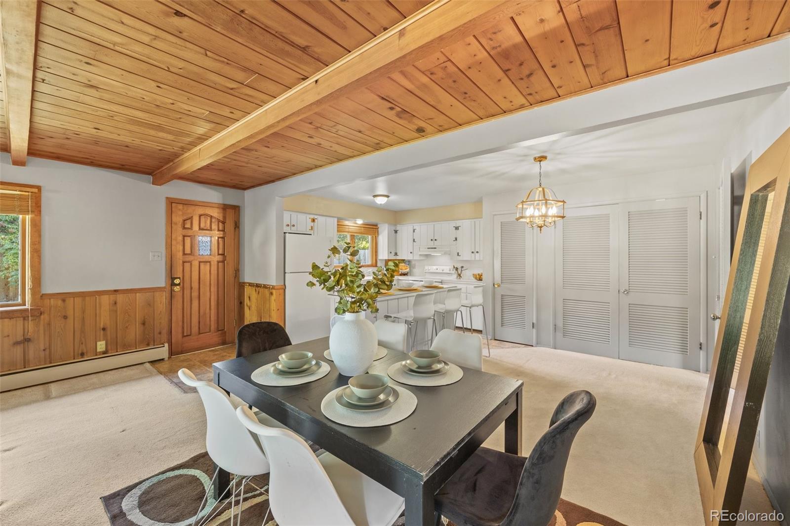13780 Crabapple Road Golden, CO 80401 - Photo 2 of 39 a view of a dining room with furniture and wooden floor