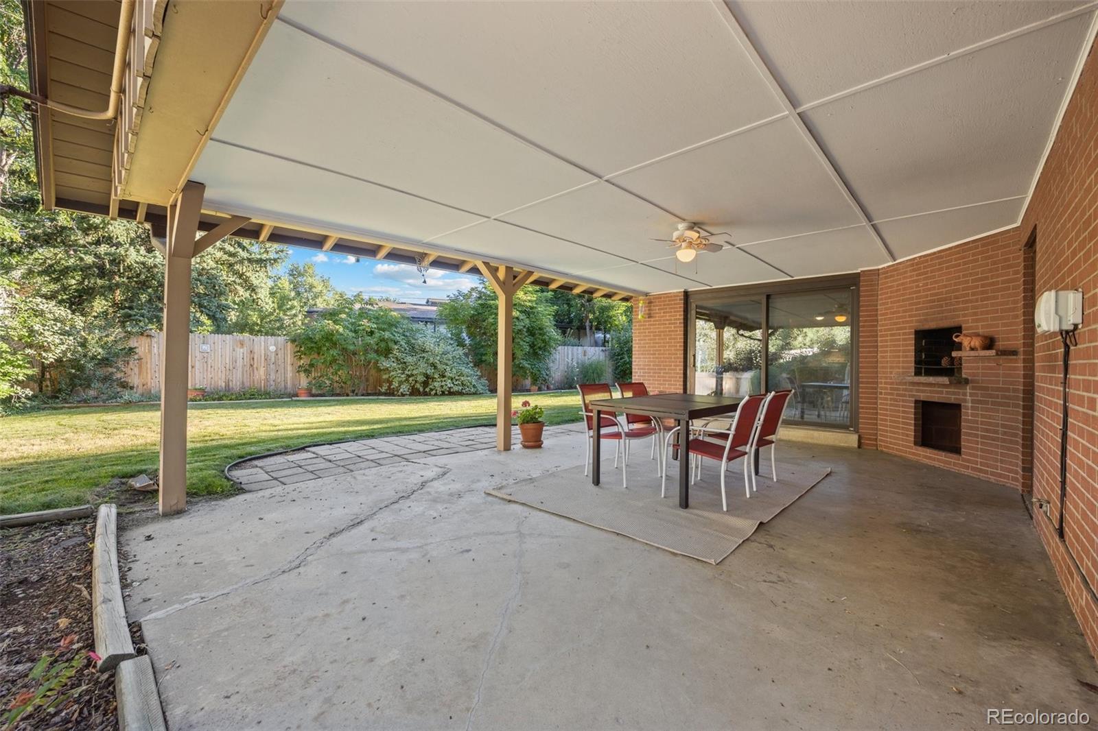 13780 Crabapple Road Golden, CO 80401 - Photo 22 of 39 a view of a patio with a table and chairs under an umbrella