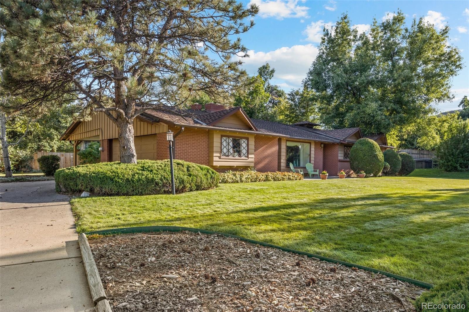 13780 Crabapple Road Golden, CO 80401 - Photo 24 of 39 a front view of a house with a garden