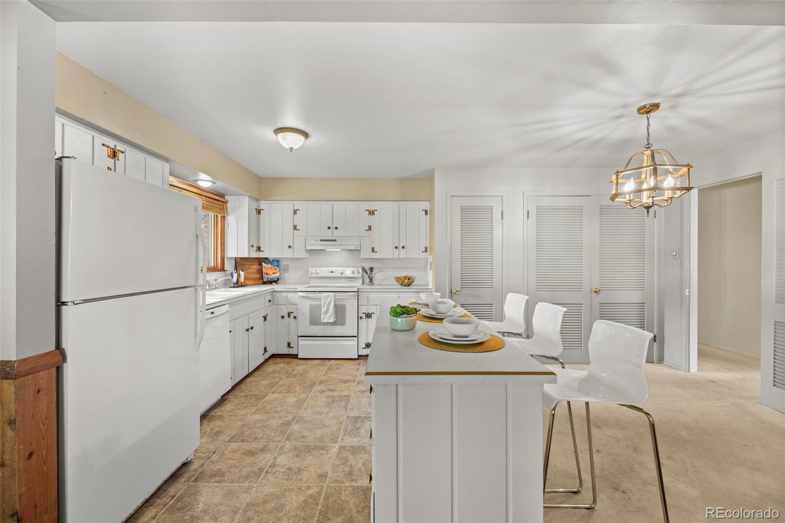 13780 Crabapple Road Golden, CO 80401 - Photo 4 of 39 a kitchen with a refrigerator a stove a sink dishwasher a dining table and chairs with wooden floor