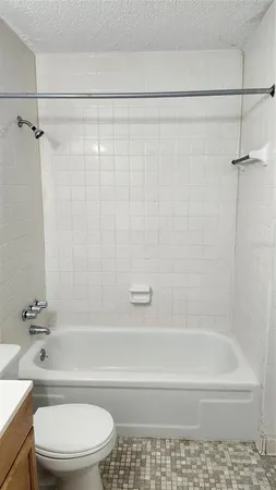 a bathroom with a toilet and a bath tub