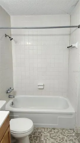 a bathroom with a toilet and a bath tub