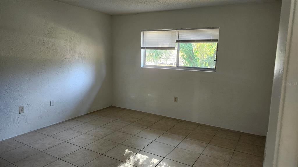1216 Kennedy Road, Unit 10 Daytona Beach, FL 32117 - Photo 12 of 14 an empty room with a window