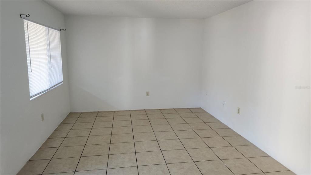 1216 Kennedy Road, Unit 10 Daytona Beach, FL 32117 - Photo 3 of 14 an empty room with white walls