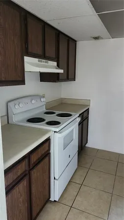 a kitchen with stainless steel appliances a stove a sink and cabinets