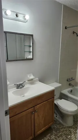 a bathroom with a sink a toilet and mirror