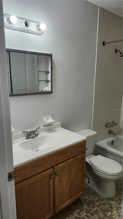 1216 Kennedy Road, Unit 10 Daytona Beach, FL 32117 - Photo 10 of 14 a bathroom with a sink a toilet and mirror