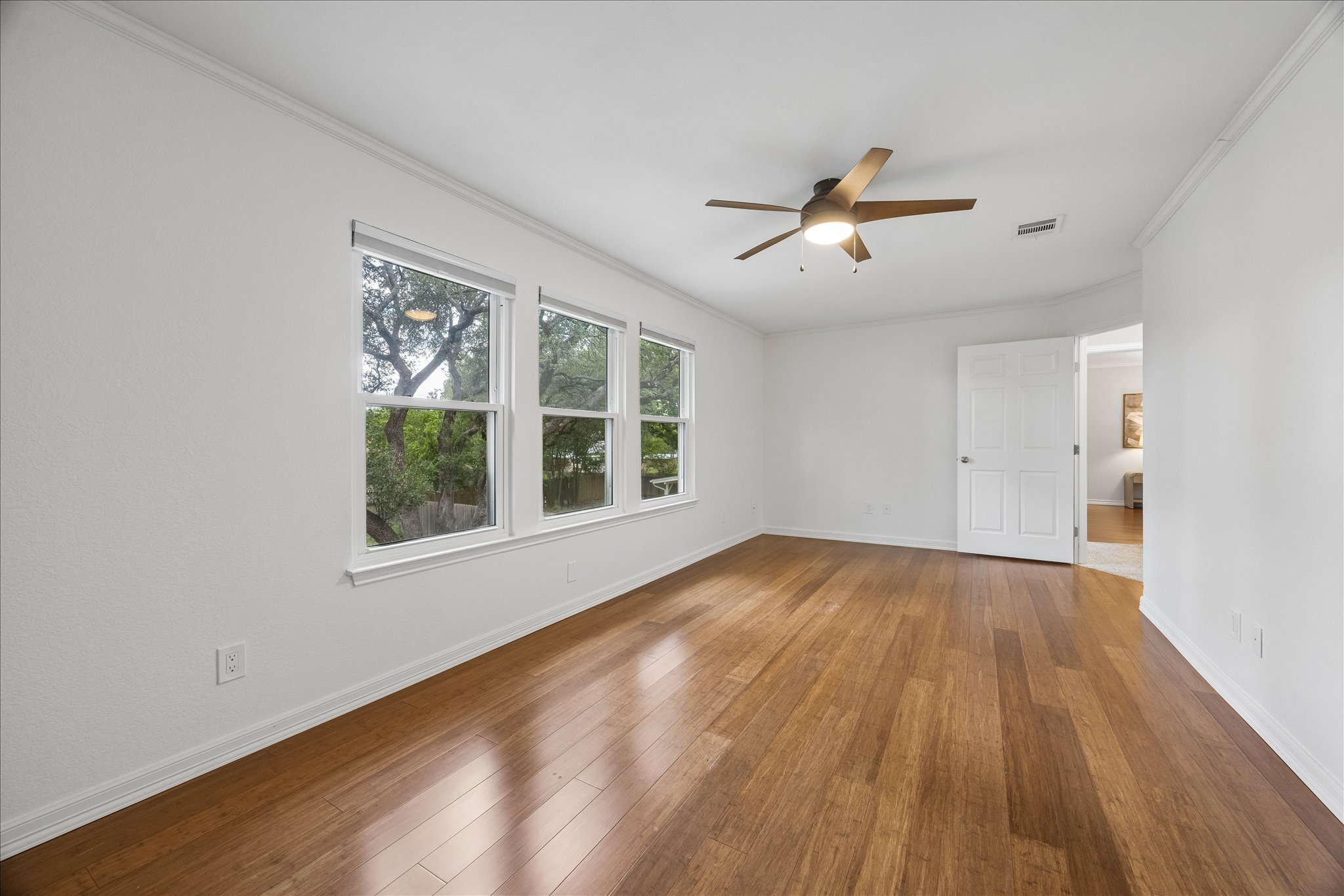 1306 Shady Grove Path Cedar Park, TX 78613 - Photo 26 of 40 a view of an empty room with wooden floor and a window