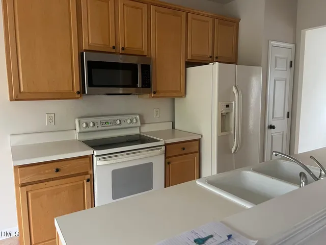 a kitchen with stainless steel appliances a refrigerator stove and sink