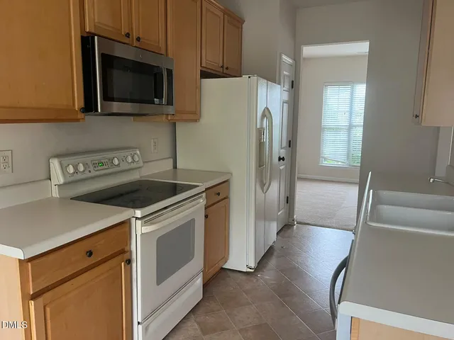 a kitchen with a stove microwave and refrigerator