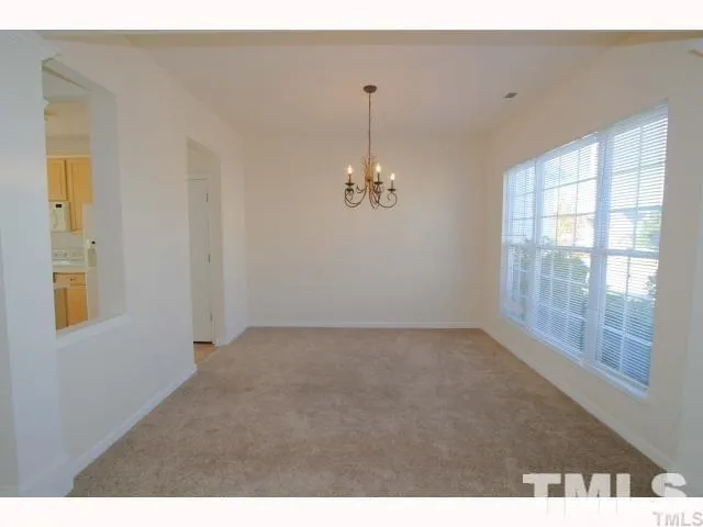 a view of a kitchen with a sink and a refrigerator