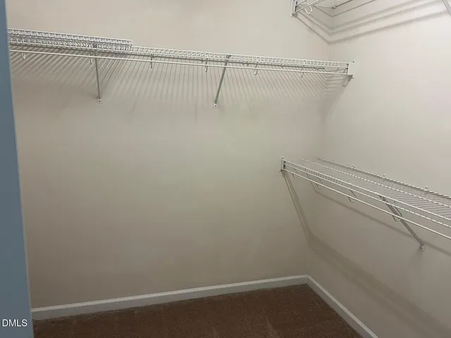 a white toilet sitting next to a shower